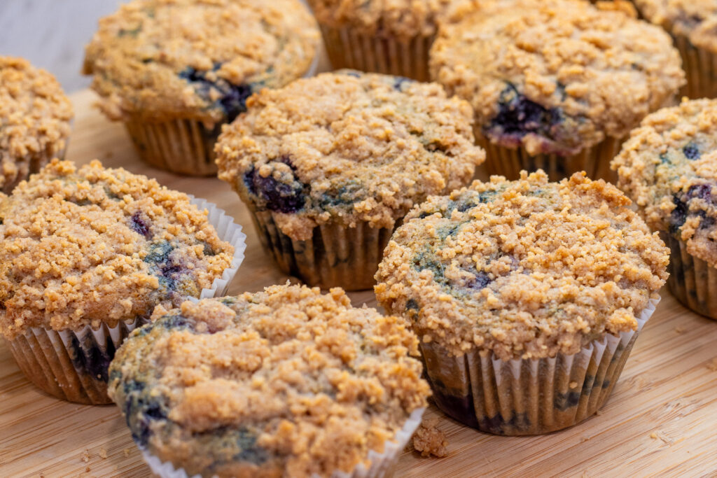 Best Blueberry Buttermilk  Muffin Recipe with Streusel Top cooling on countertop close-up